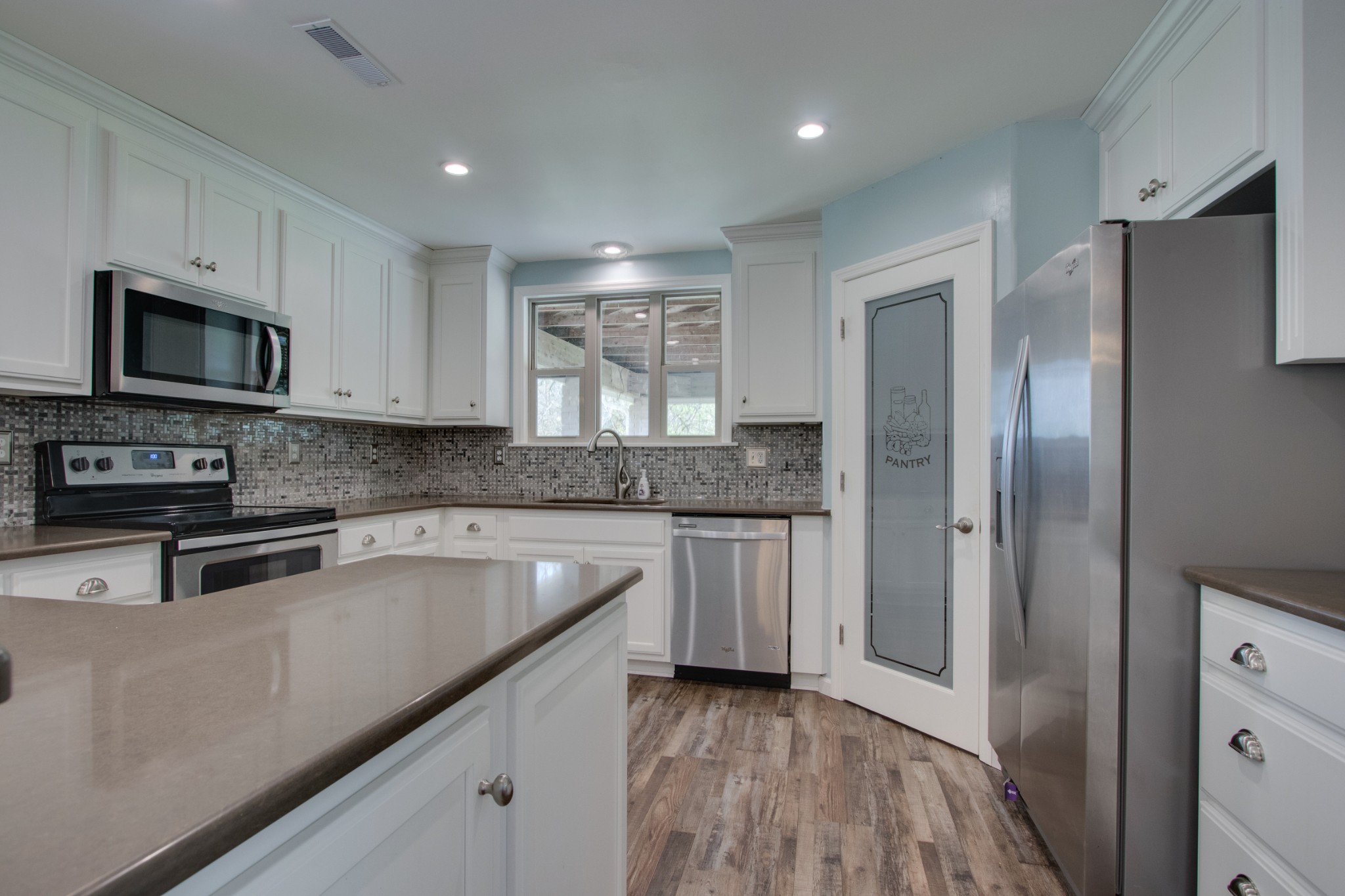 445 Tracy Road Watertown, TN 37184 - Photo 11 of 49 a kitchen with stainless steel appliances granite countertop a refrigerator and a stove top oven