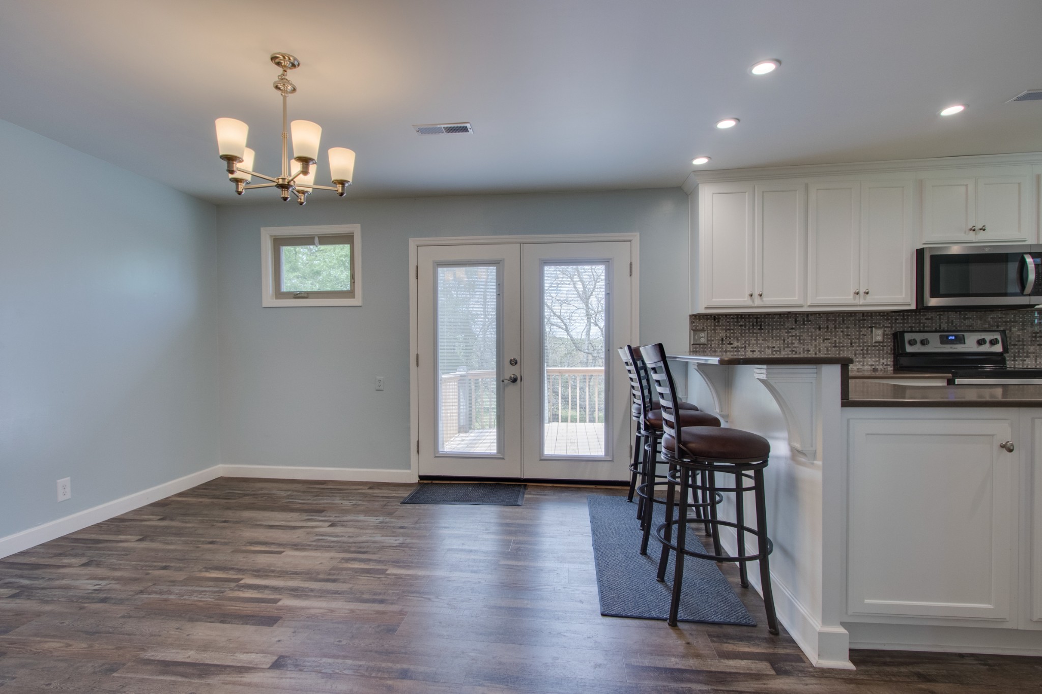445 Tracy Road Watertown, TN 37184 - Photo 9 of 49 a view of a dining room with furniture a chandelier and wooden floor