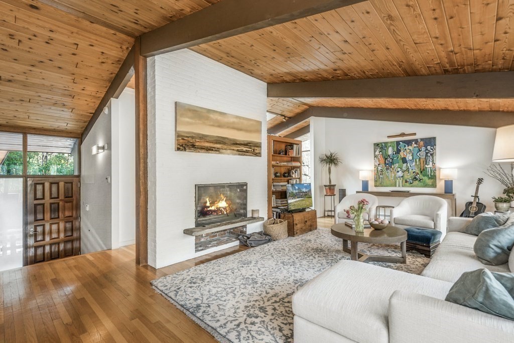 246 Heald Road Carlisle, MA 01741 - Photo 5 of 25 a living room with furniture and a fireplace