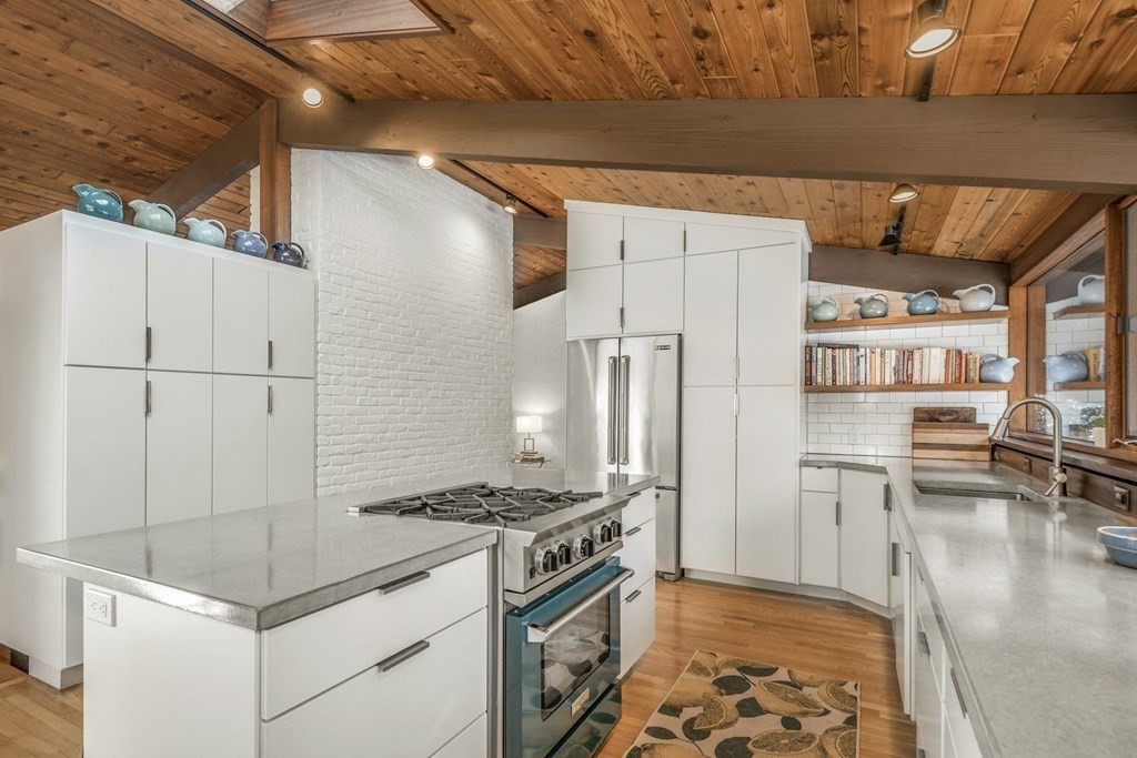 246 Heald Road Carlisle, MA 01741 - Photo 8 of 25 a kitchen with stainless steel appliances granite countertop a refrigerator and a stove