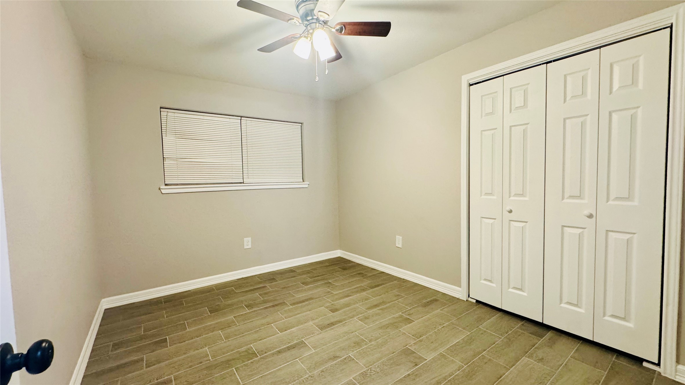 202 Massey Tompkins Road Baytown, TX 77521 - Photo 11 of 20 an empty room with wooden floor closet and windows