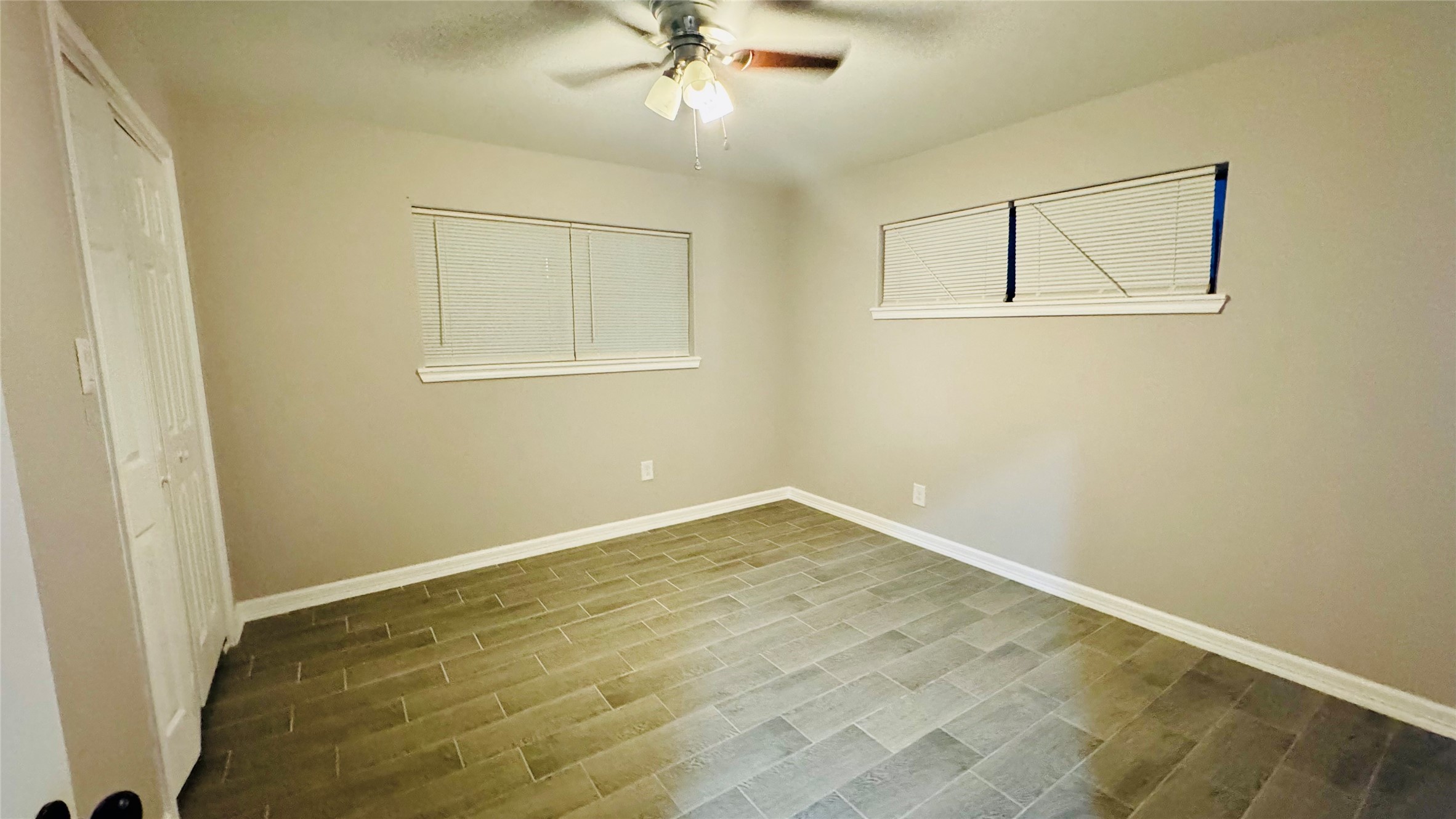 202 Massey Tompkins Road Baytown, TX 77521 - Photo 9 of 20 wooden floor in an empty room with a window