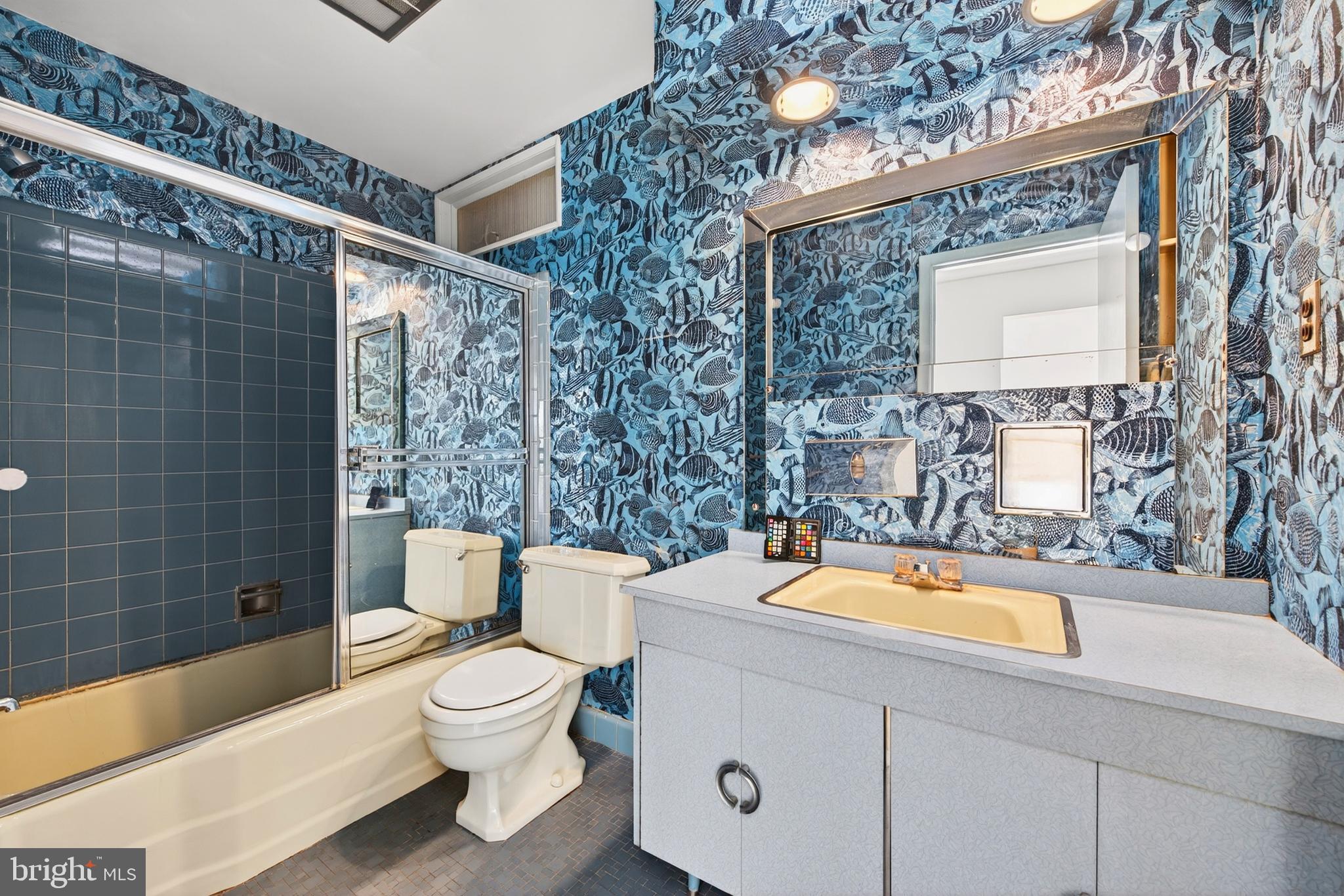 914 Kenbrook Court Silver Spring, MD 20902 - Photo 26 of 35 a bathroom with a sink a toilet a mirror and bathtub