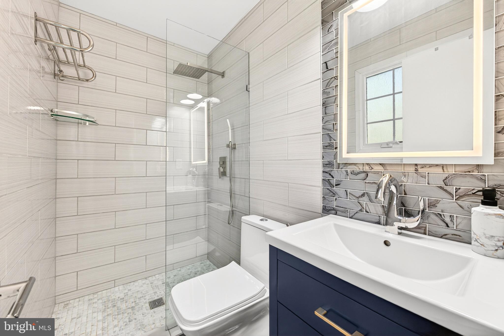 914 Kenbrook Court Silver Spring, MD 20902 - Photo 29 of 35 a bathroom with a sink a toilet and shower