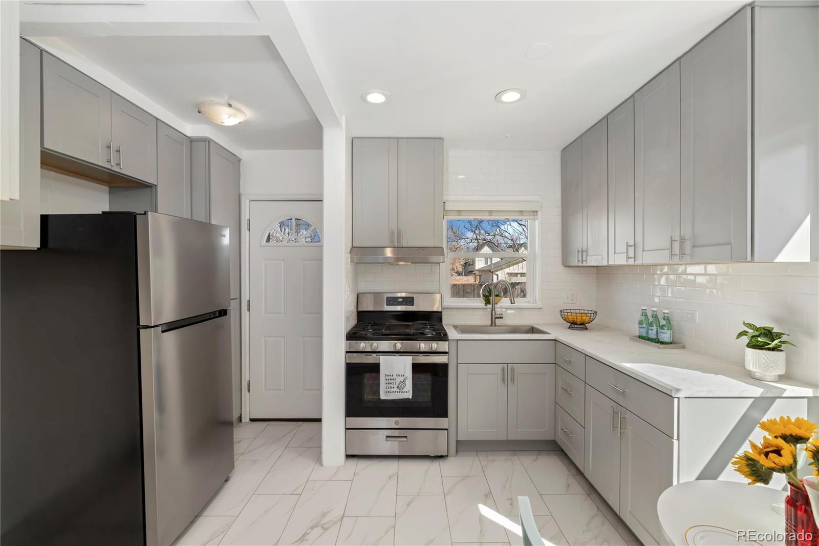 a kitchen with a white cabinets and white stainless steel appliances