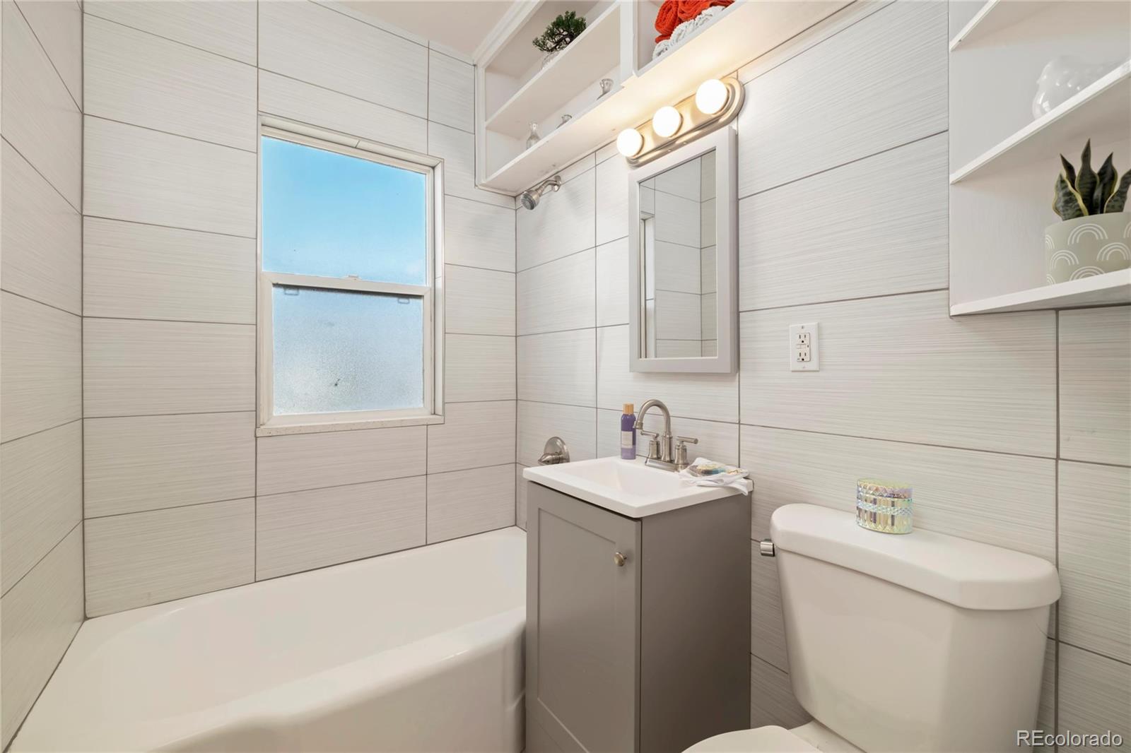 2570 Jay Street Edgewater, CO 80214 - Photo 12 of 26 a bathroom with a sink a toilet and shower