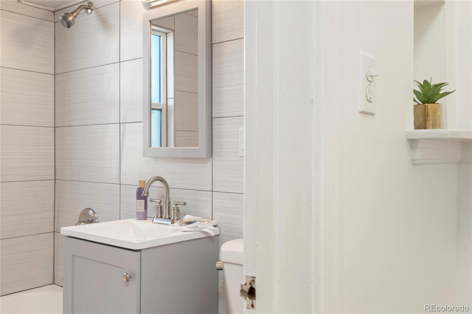 2570 Jay Street Edgewater, CO 80214 - Photo 13 of 26 a bathroom with a sink toilet and mirror