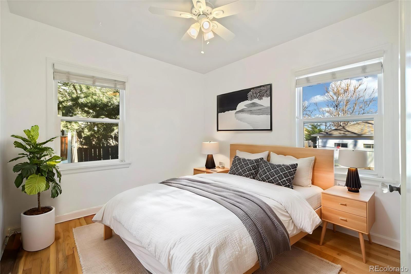 2570 Jay Street Edgewater, CO 80214 - Photo 14 of 26 a bedroom with a large bed and a potted plant