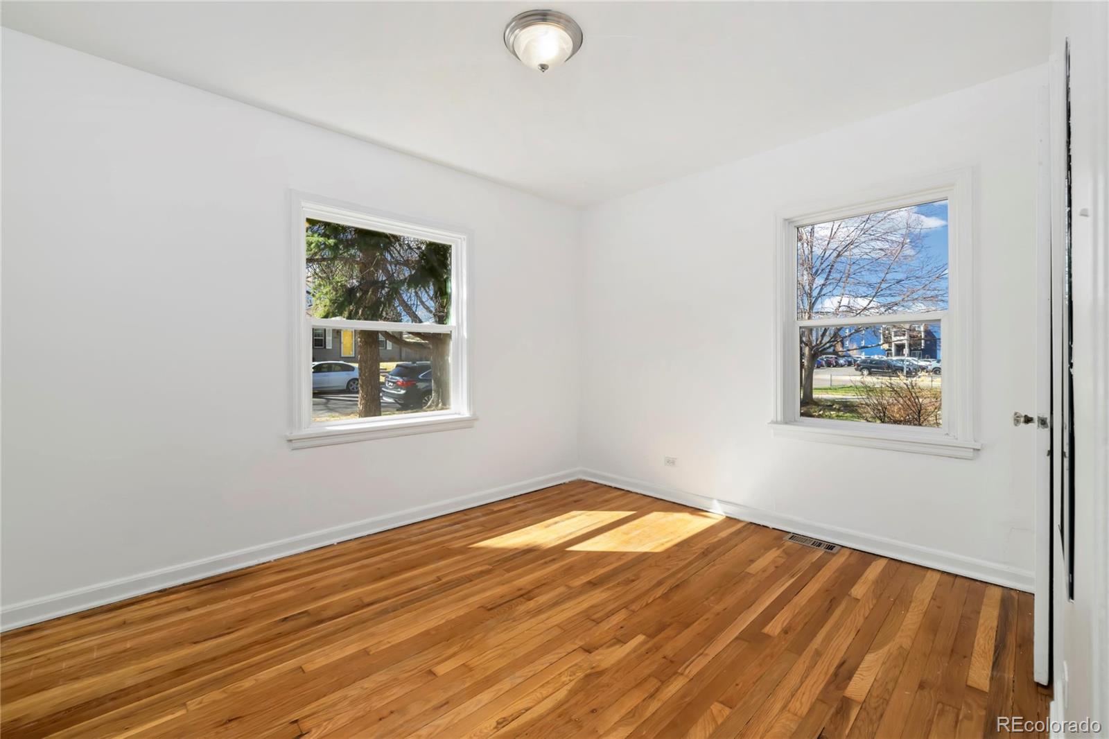 2570 Jay Street Edgewater, CO 80214 - Photo 15 of 26 a view of an empty room with window and wooden floor