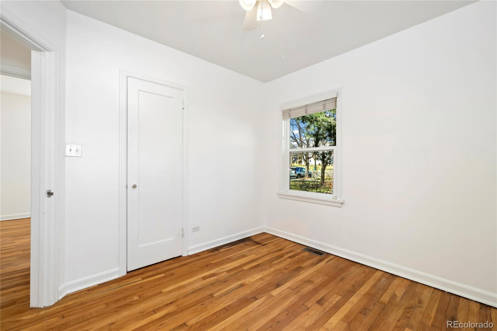 2570 Jay Street Edgewater, CO 80214 - Photo 19 of 26 a view of an empty room with wooden floor and a window