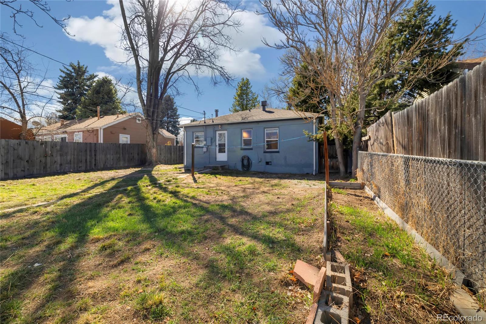2570 Jay Street Edgewater, CO 80214 - Photo 20 of 26 a view of yard with large trees and wooden fence
