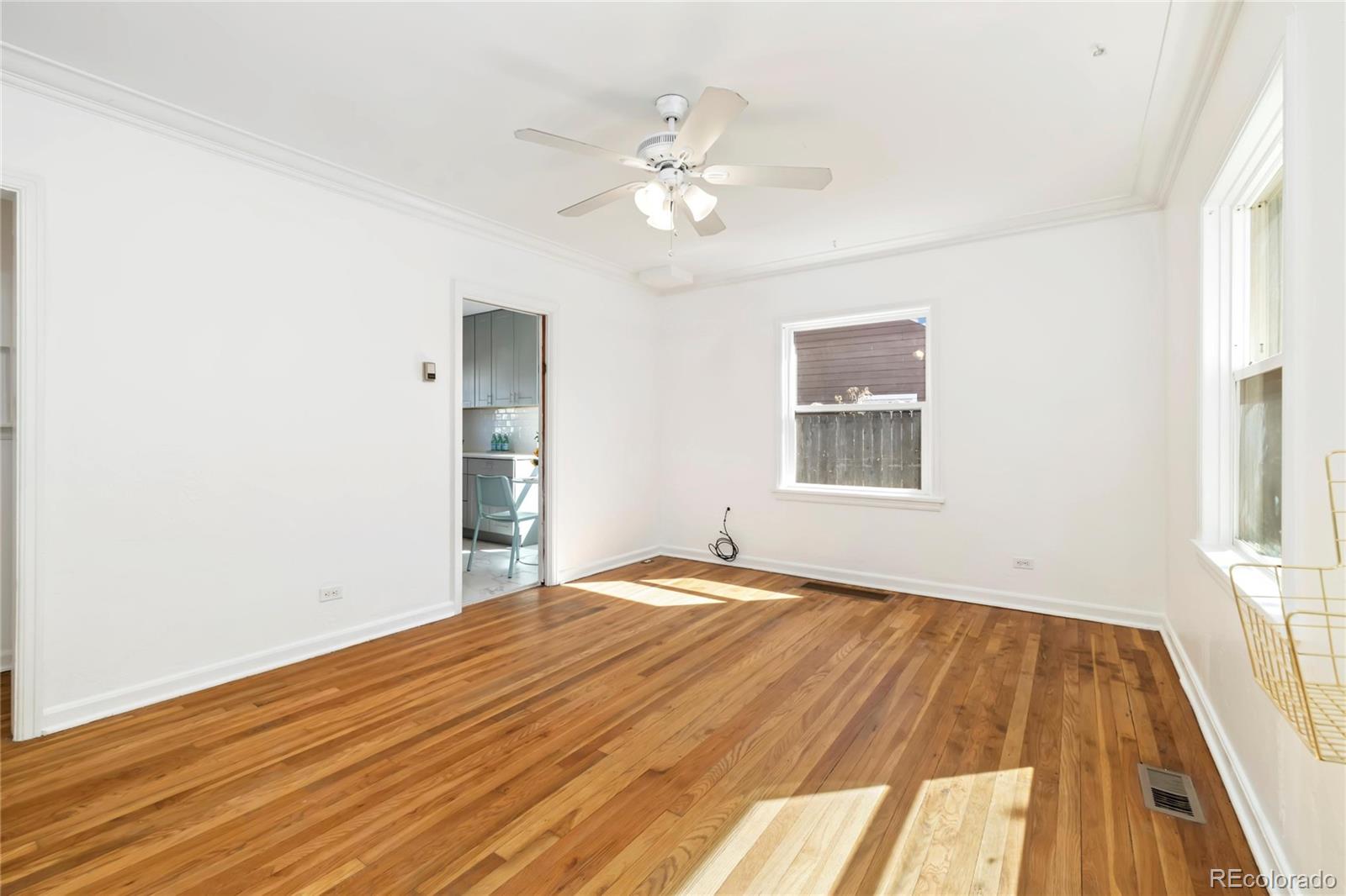 2570 Jay Street Edgewater, CO 80214 - Photo 5 of 26 a view of an empty room with wooden floor and a window