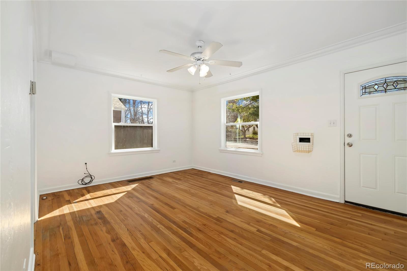 2570 Jay Street Edgewater, CO 80214 - Photo 6 of 26 a view of empty room with wooden floor and fan