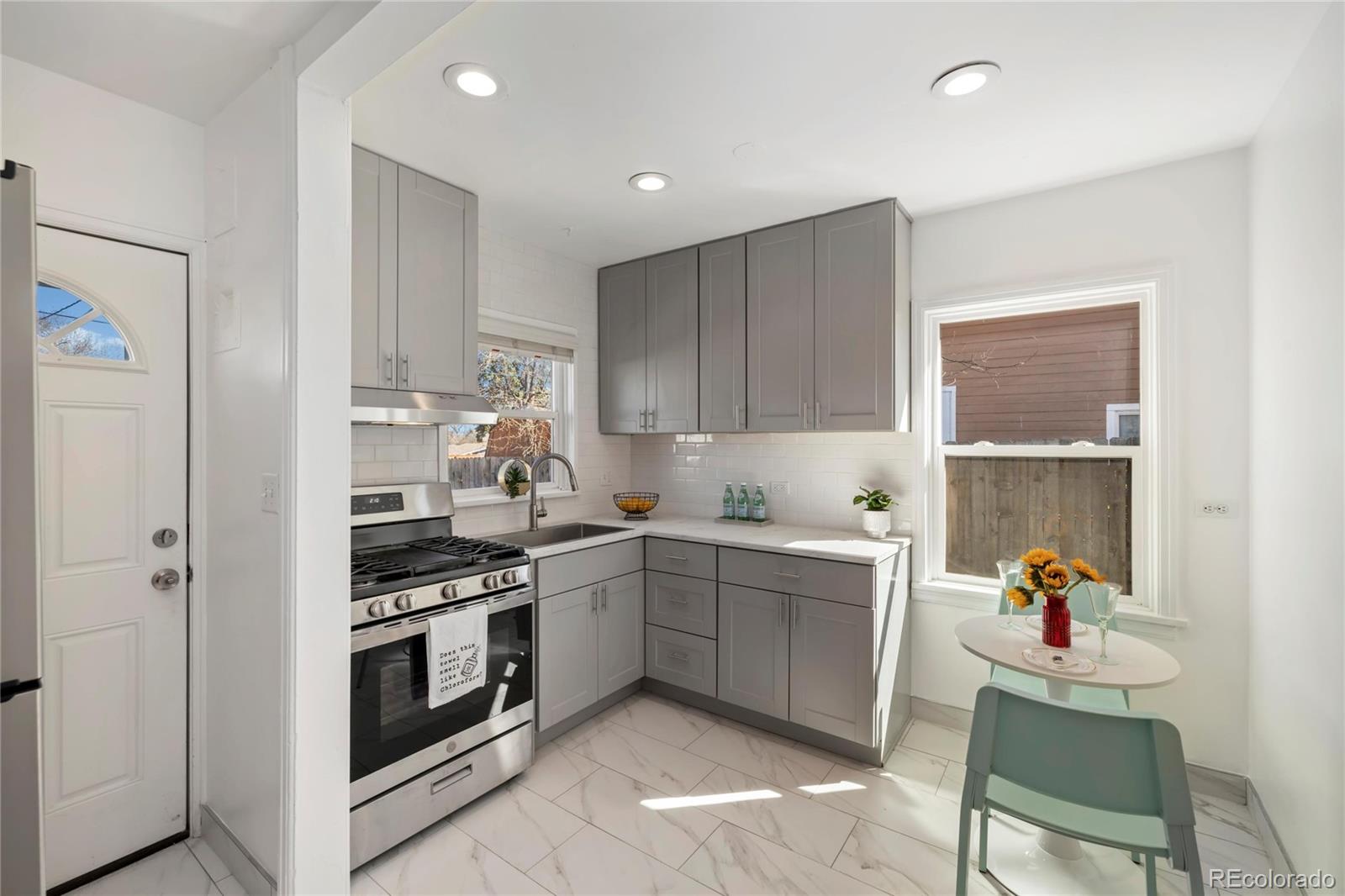 2570 Jay Street Edgewater, CO 80214 - Photo 10 of 26 a kitchen with a stove a sink and a refrigerator