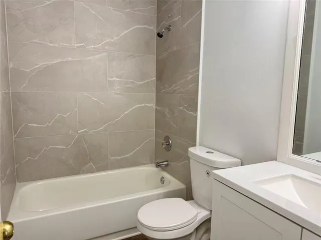 a bathroom with a toilet and a bath tub