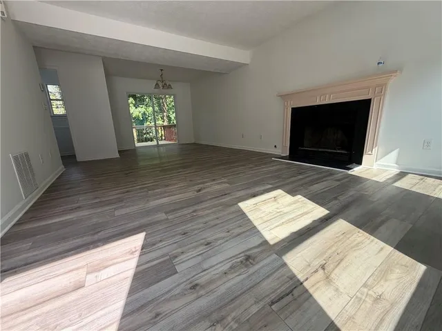 a view of an empty room and fire place