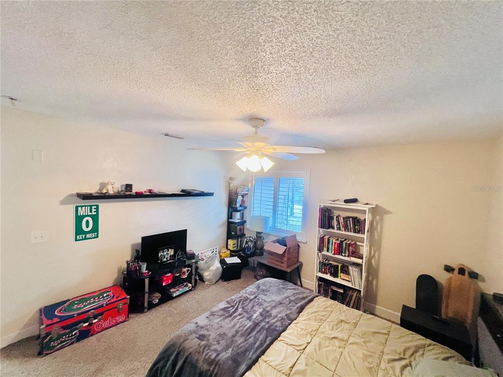 357 Tymber Run Ormond Beach, FL 32174 - Photo 22 of 32 a bedroom with furniture and a fireplace