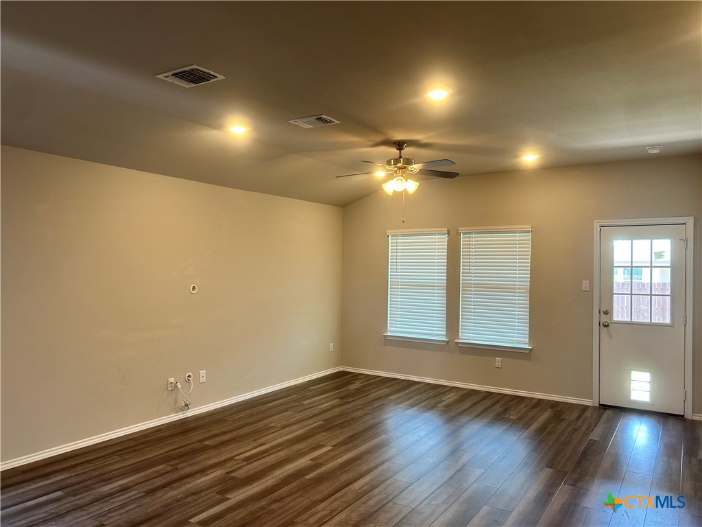 8419 Brahma Plns Road Temple, TX 76502 - Photo 4 of 17 a view of an empty room with wooden floor and a window