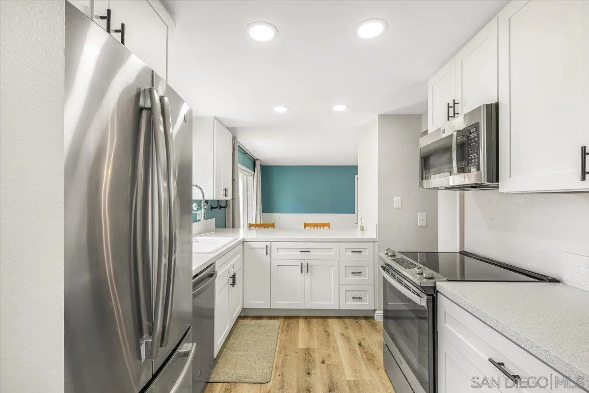 8335 Carlton Oaks Drive Santee, CA 92071 - Photo 11 of 32 a kitchen with stainless steel appliances a sink stove and refrigerator