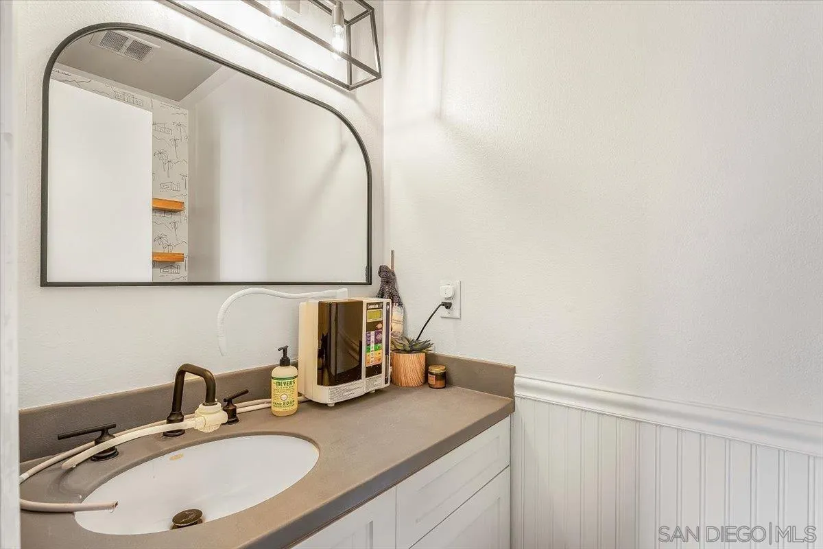 8335 Carlton Oaks Drive Santee, CA 92071 - Photo 12 of 32 a bathroom with a sink and a mirror