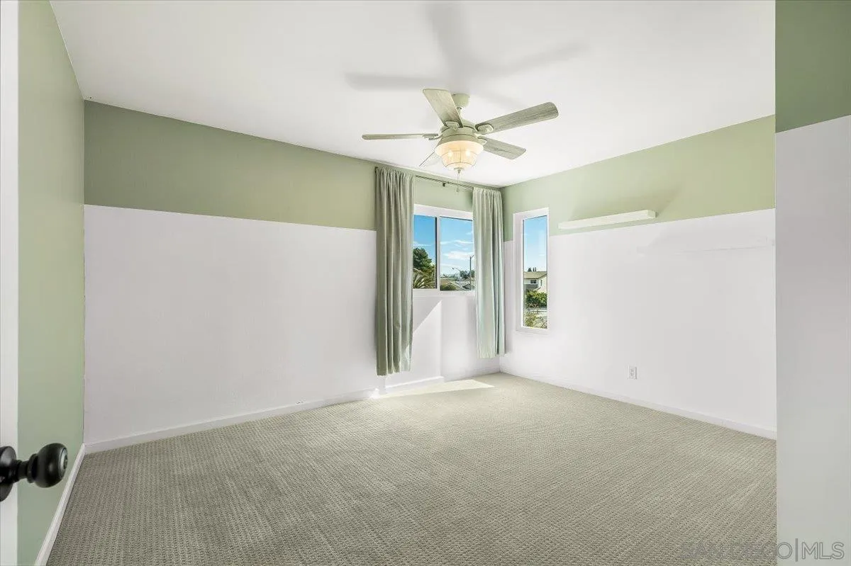 8335 Carlton Oaks Drive Santee, CA 92071 - Photo 18 of 32 a view of a big room with closet and a ceiling fan