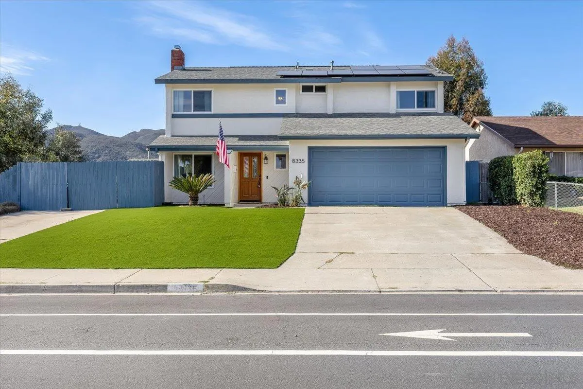 8335 Carlton Oaks Drive Santee, CA 92071 - Photo 2 of 32 a front view of a house with a yard and garage