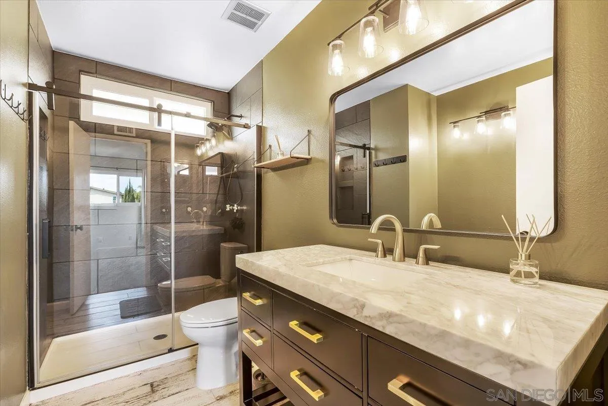 8335 Carlton Oaks Drive Santee, CA 92071 - Photo 25 of 32 a bathroom with a granite countertop sink mirror and shower