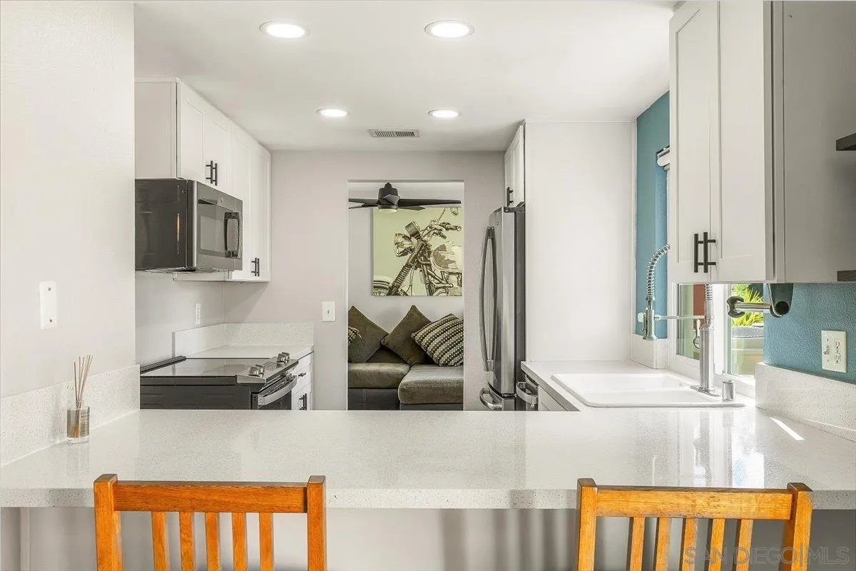 8335 Carlton Oaks Drive Santee, CA 92071 - Photo 8 of 32 a living room with furniture and a flat screen tv