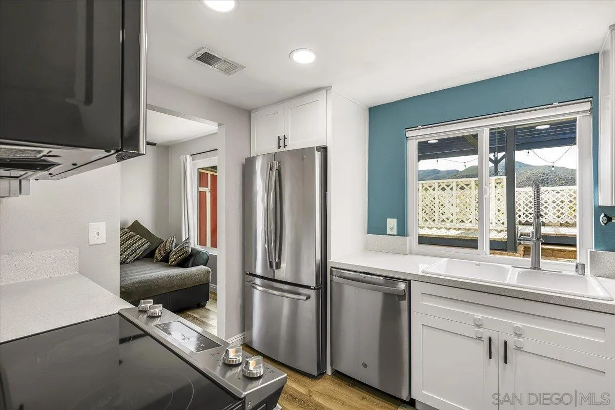 8335 Carlton Oaks Drive Santee, CA 92071 - Photo 10 of 32 a kitchen with refrigerator and window
