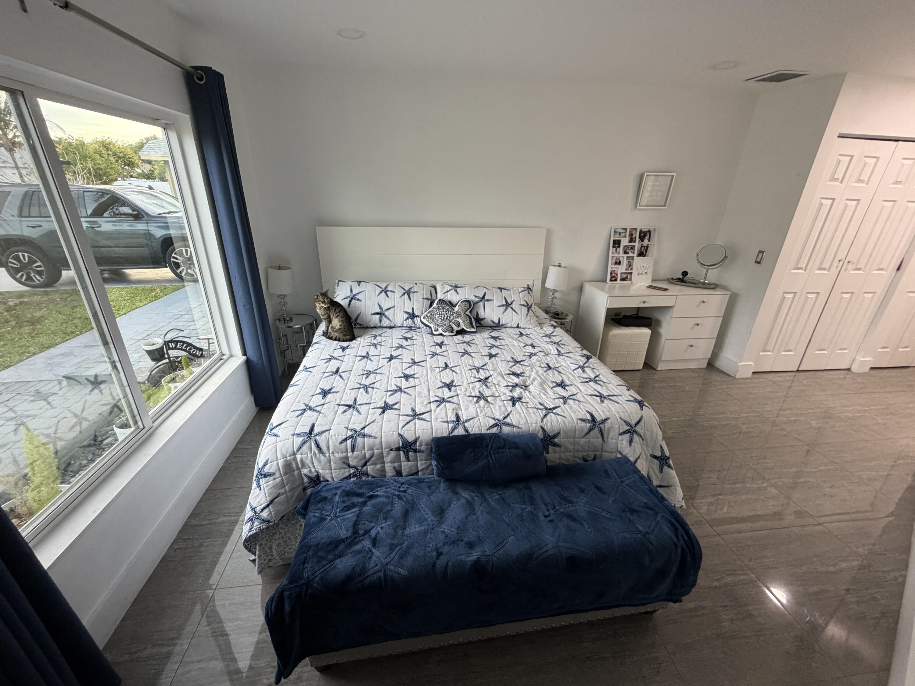 8097 Cedar Hollow Lane Boca Raton, FL 33433 - Photo 11 of 36 a bedroom with a bed and a large window