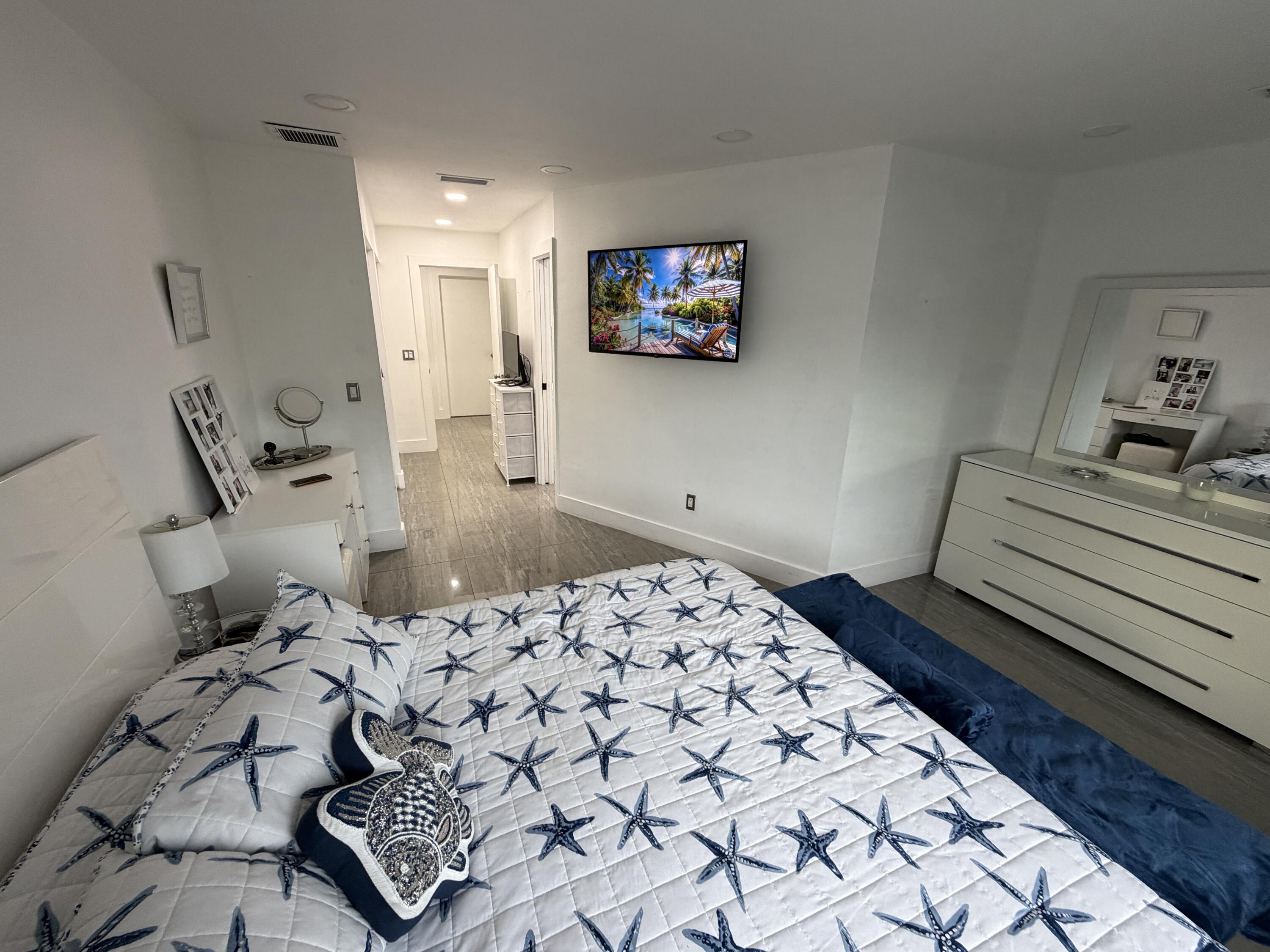 8097 Cedar Hollow Lane Boca Raton, FL 33433 - Photo 12 of 36 a bedroom with a bed and a couch