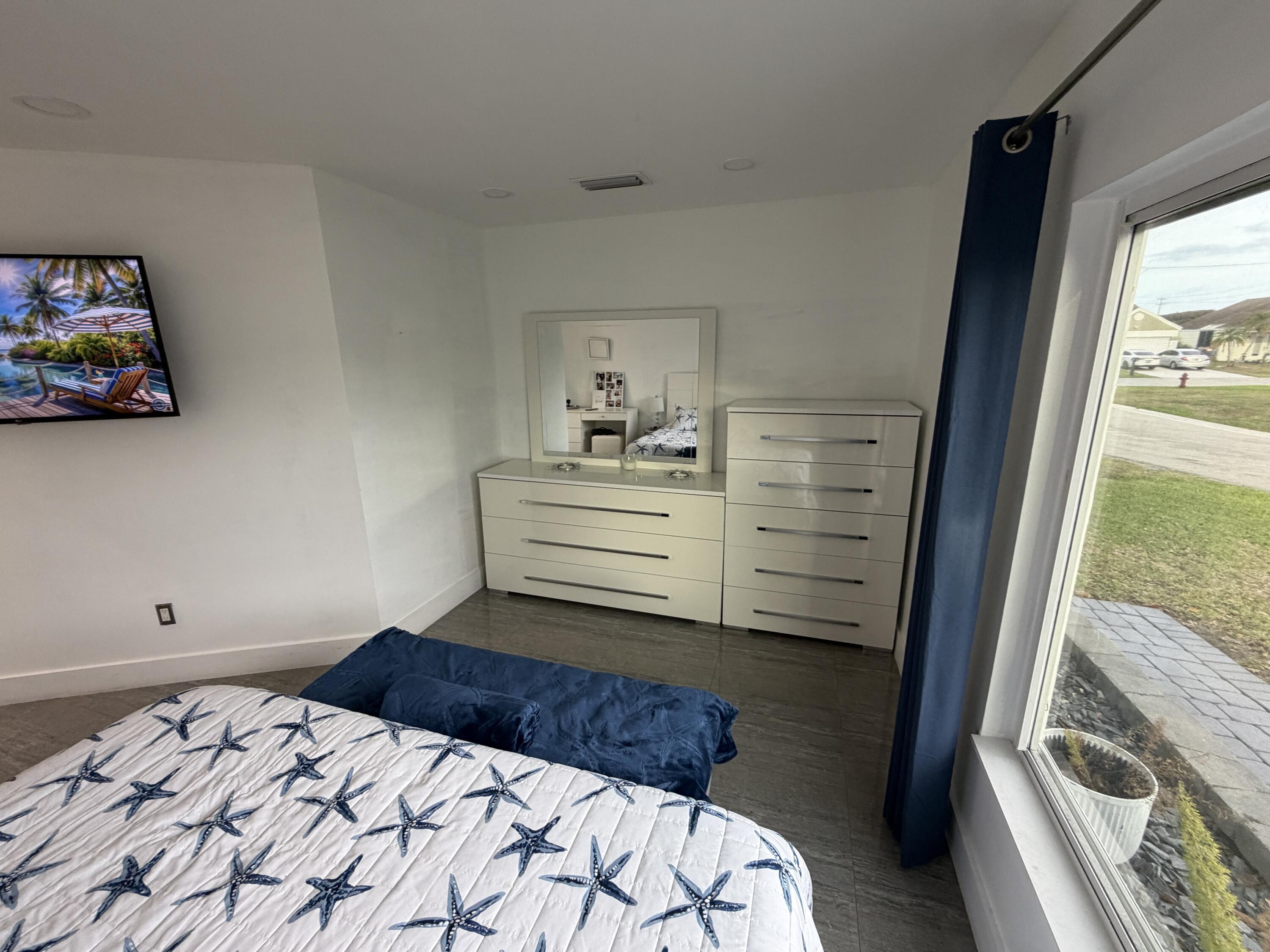 8097 Cedar Hollow Lane Boca Raton, FL 33433 - Photo 13 of 36 a bedroom with a bed and a window