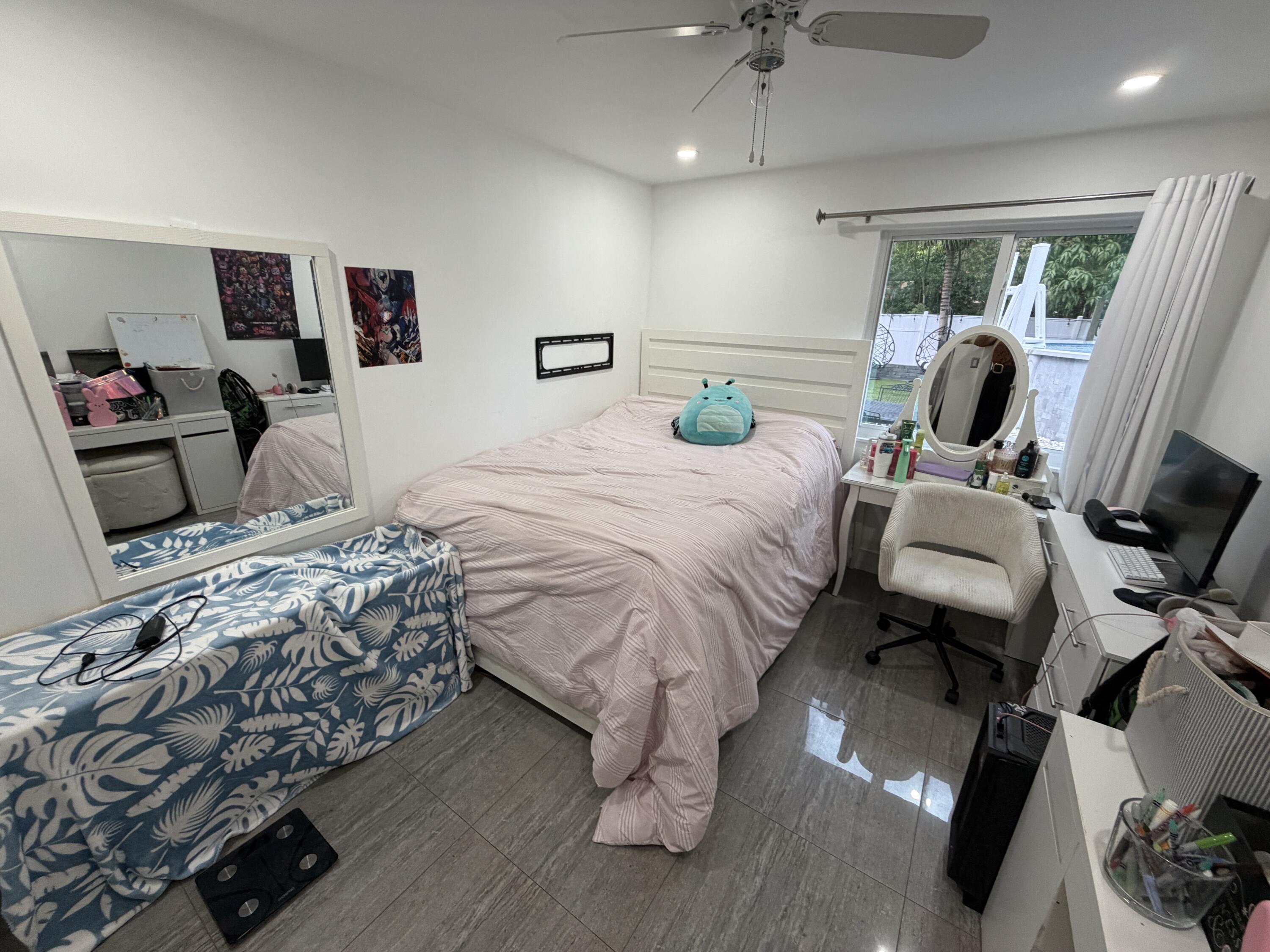 8097 Cedar Hollow Lane Boca Raton, FL 33433 - Photo 16 of 36 a bedroom with a bed and a chandelier