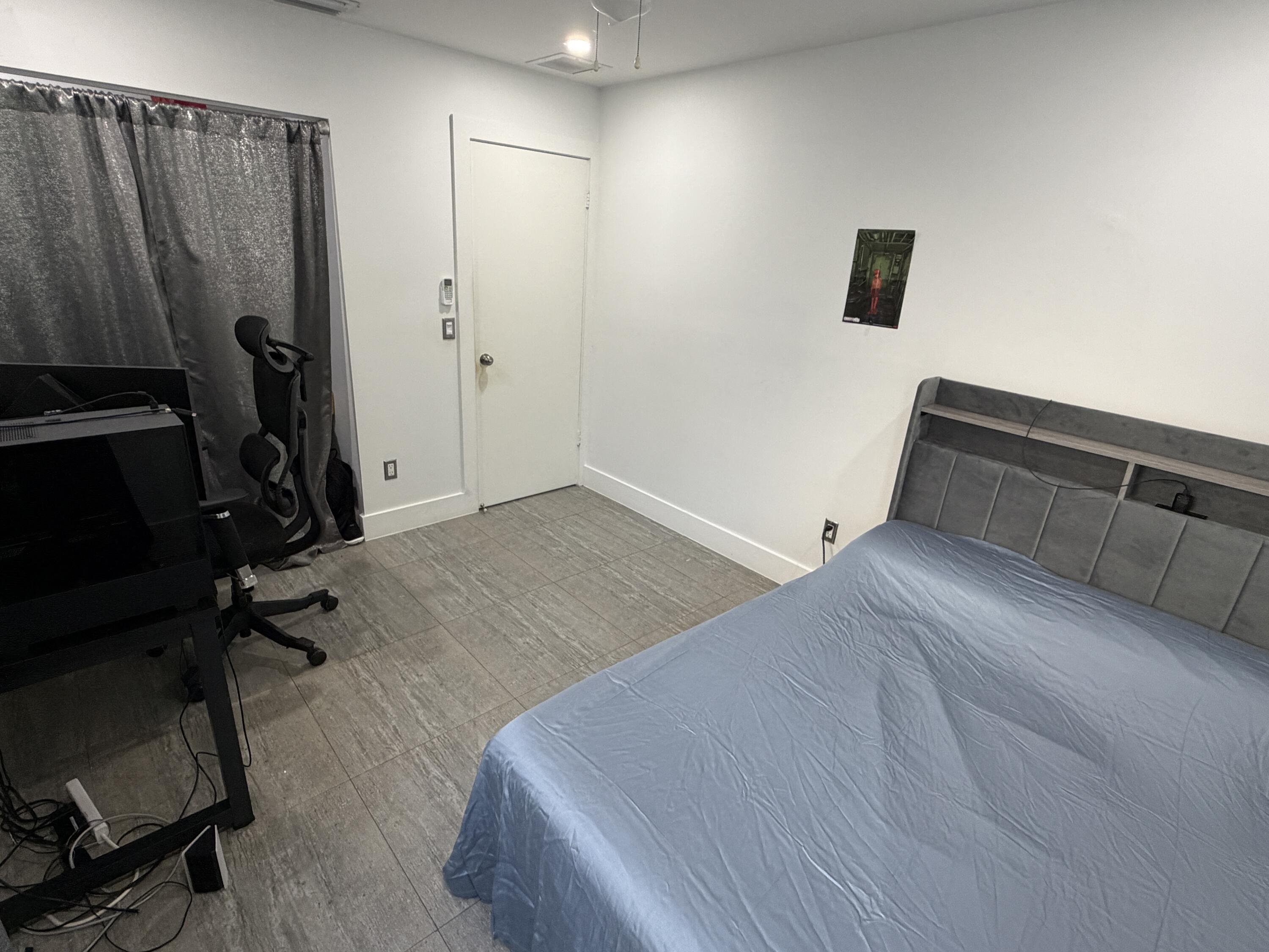 8097 Cedar Hollow Lane Boca Raton, FL 33433 - Photo 18 of 36 a view of a room with gym equipment and a large window