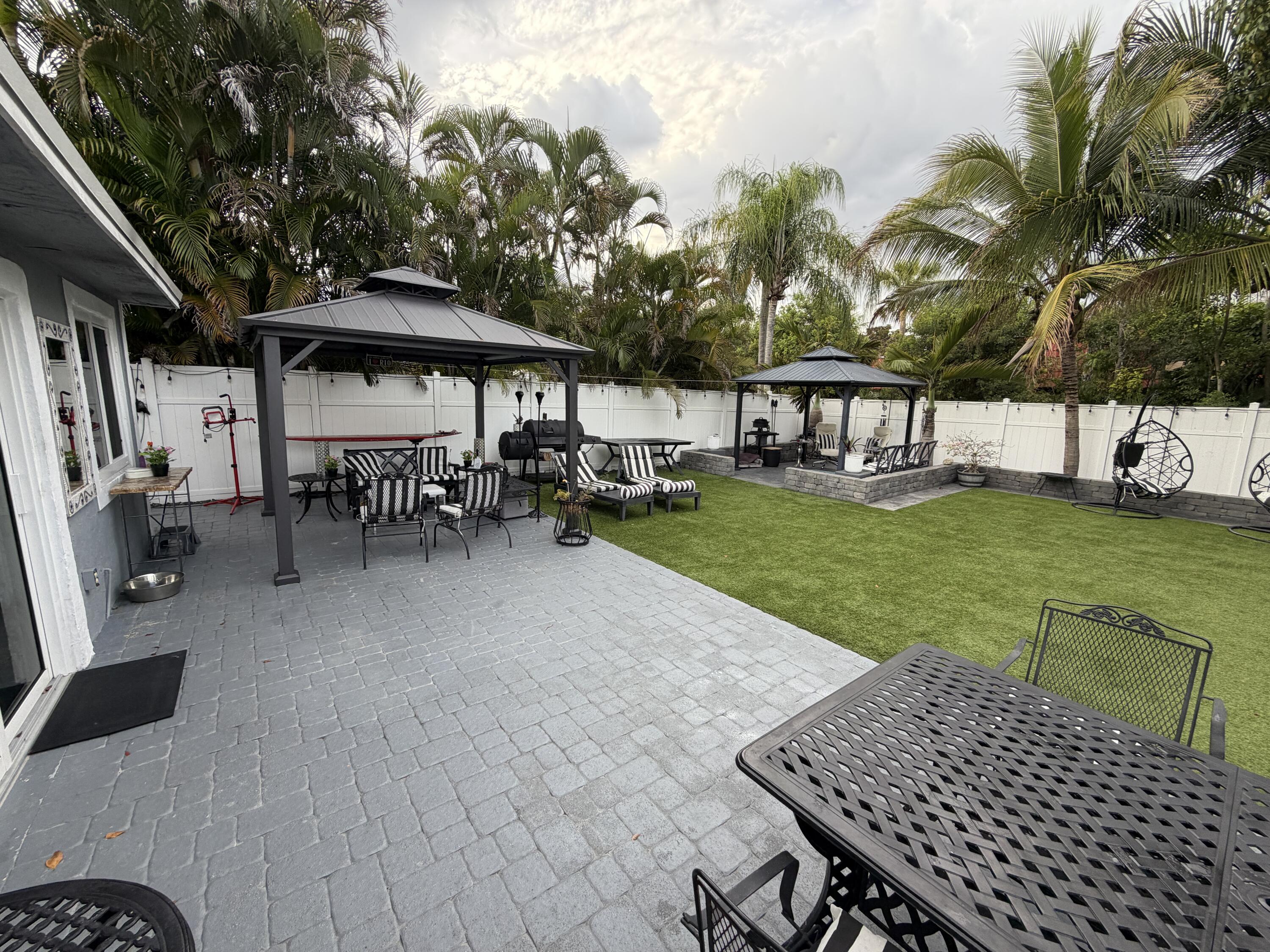 8097 Cedar Hollow Lane Boca Raton, FL 33433 - Photo 25 of 36 a view of a house with backyard and sitting area