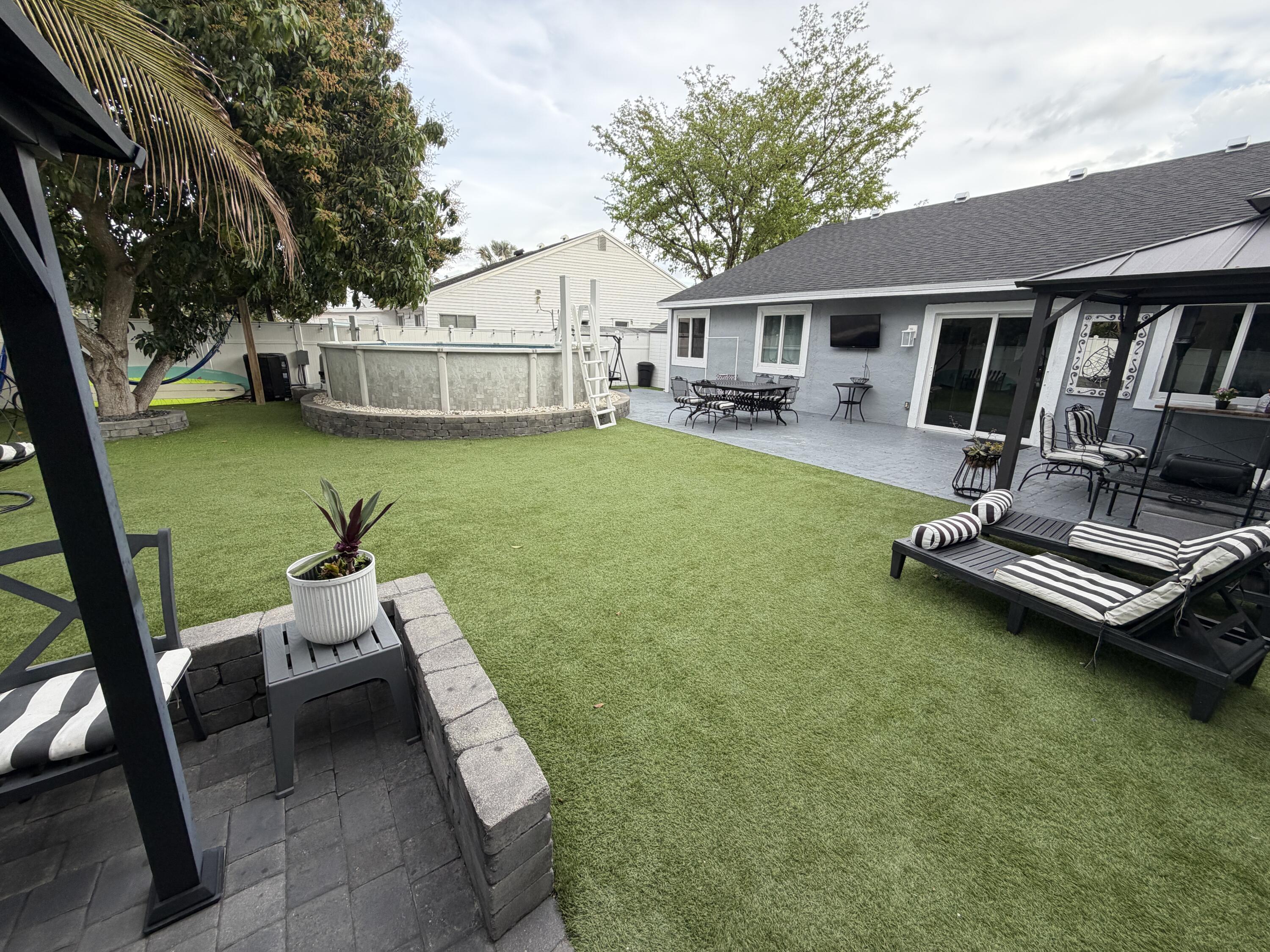 8097 Cedar Hollow Lane Boca Raton, FL 33433 - Photo 26 of 36 a view of a patio with chair and table on the patio