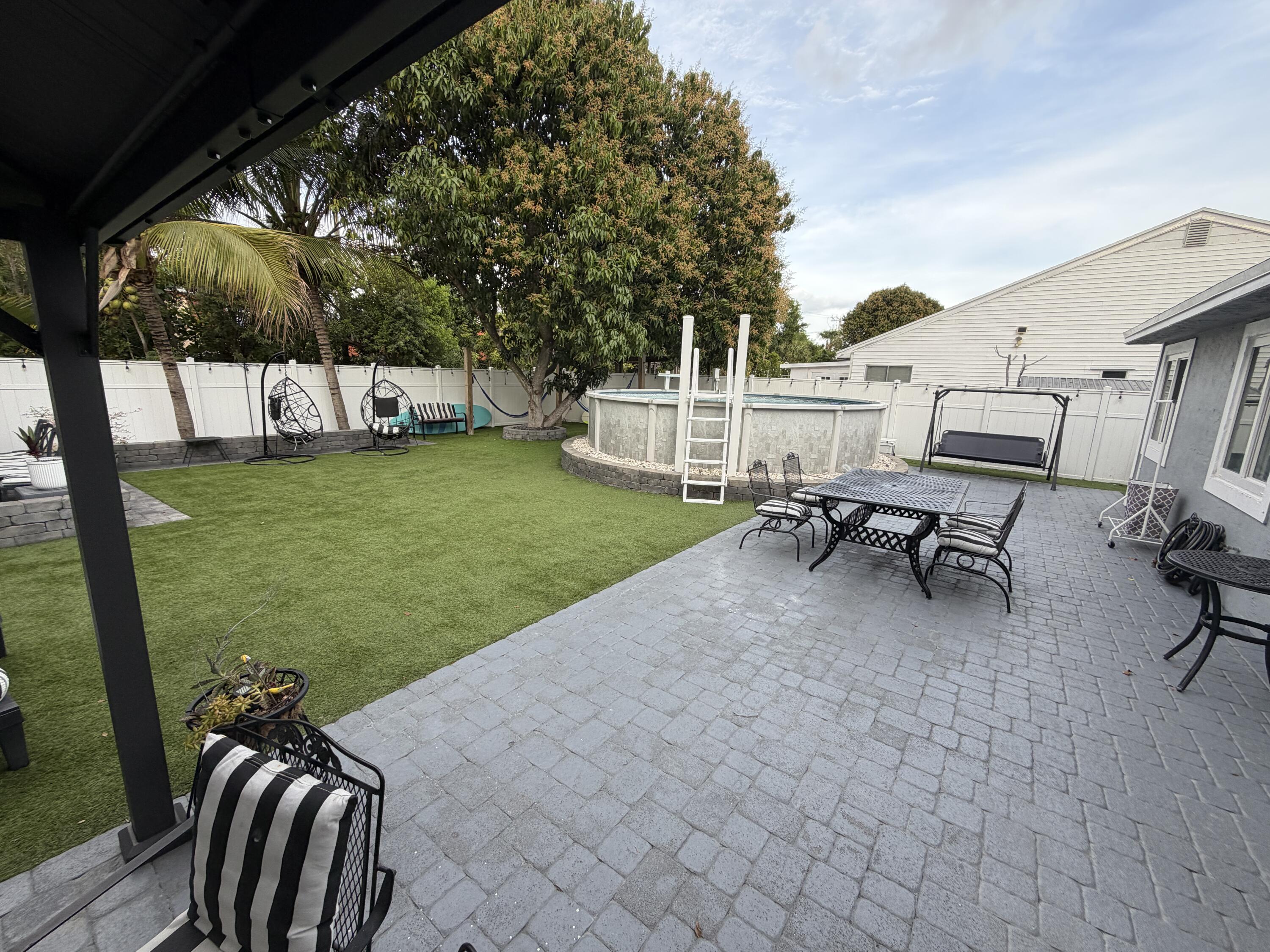 8097 Cedar Hollow Lane Boca Raton, FL 33433 - Photo 27 of 36 a view of a backyard with couches chair and yard