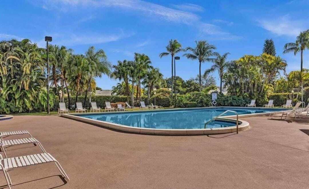 8097 Cedar Hollow Lane Boca Raton, FL 33433 - Photo 35 of 36 a view of a swimming pool with a sitting area