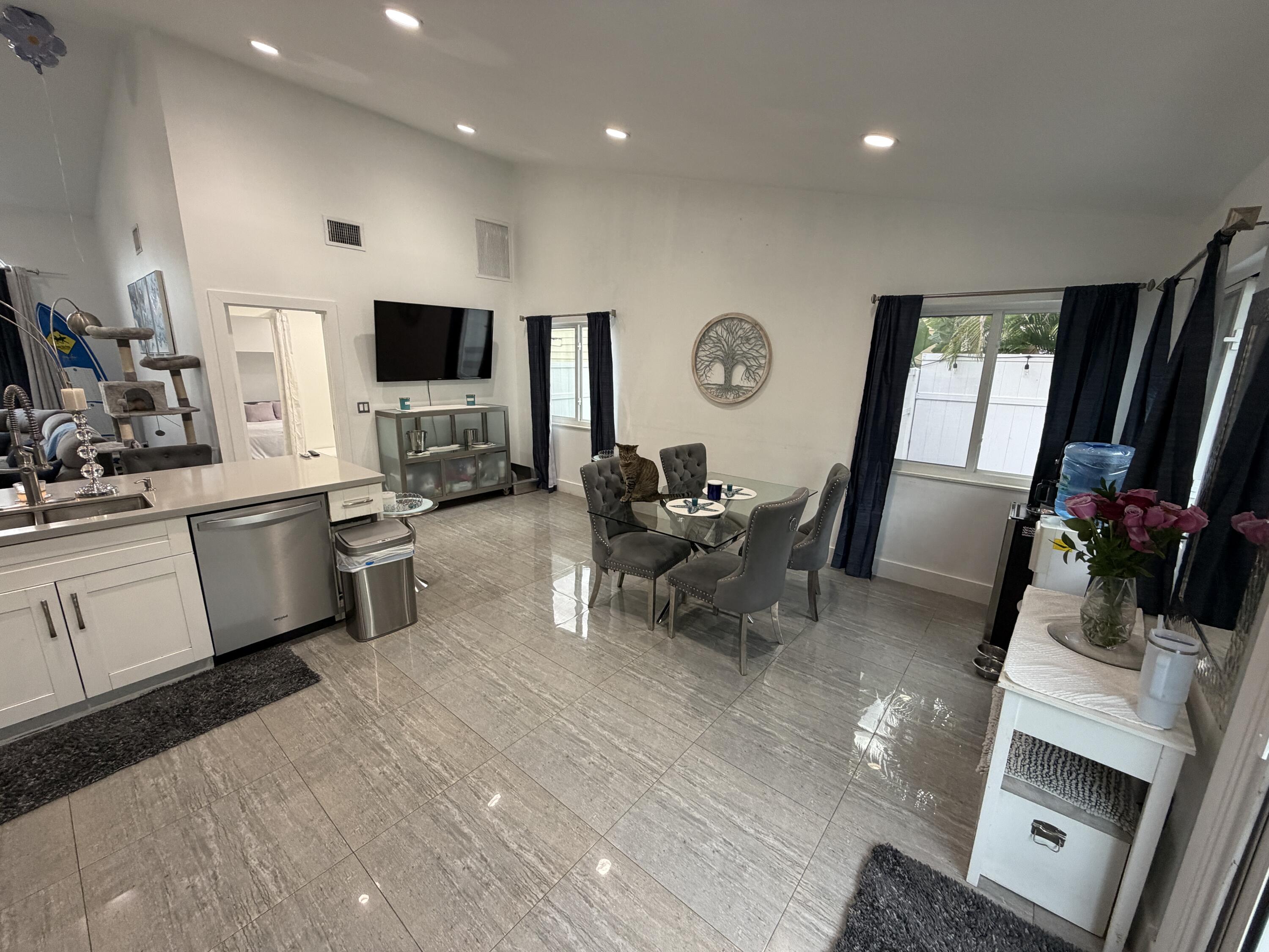8097 Cedar Hollow Lane Boca Raton, FL 33433 - Photo 5 of 36 a living room with furniture a flat screen tv and view of kitchen