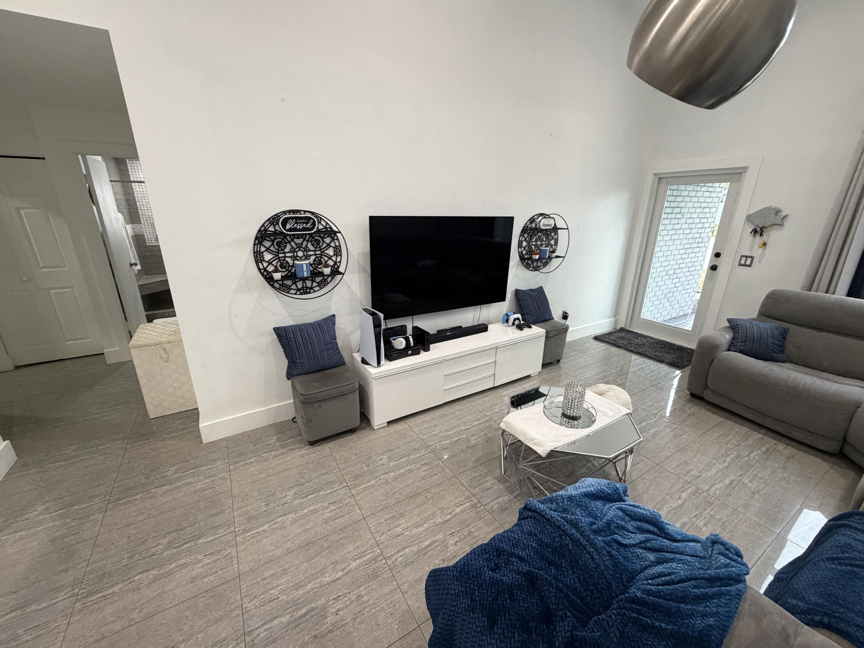 8097 Cedar Hollow Lane Boca Raton, FL 33433 - Photo 8 of 36 a living room with furniture and a flat screen tv