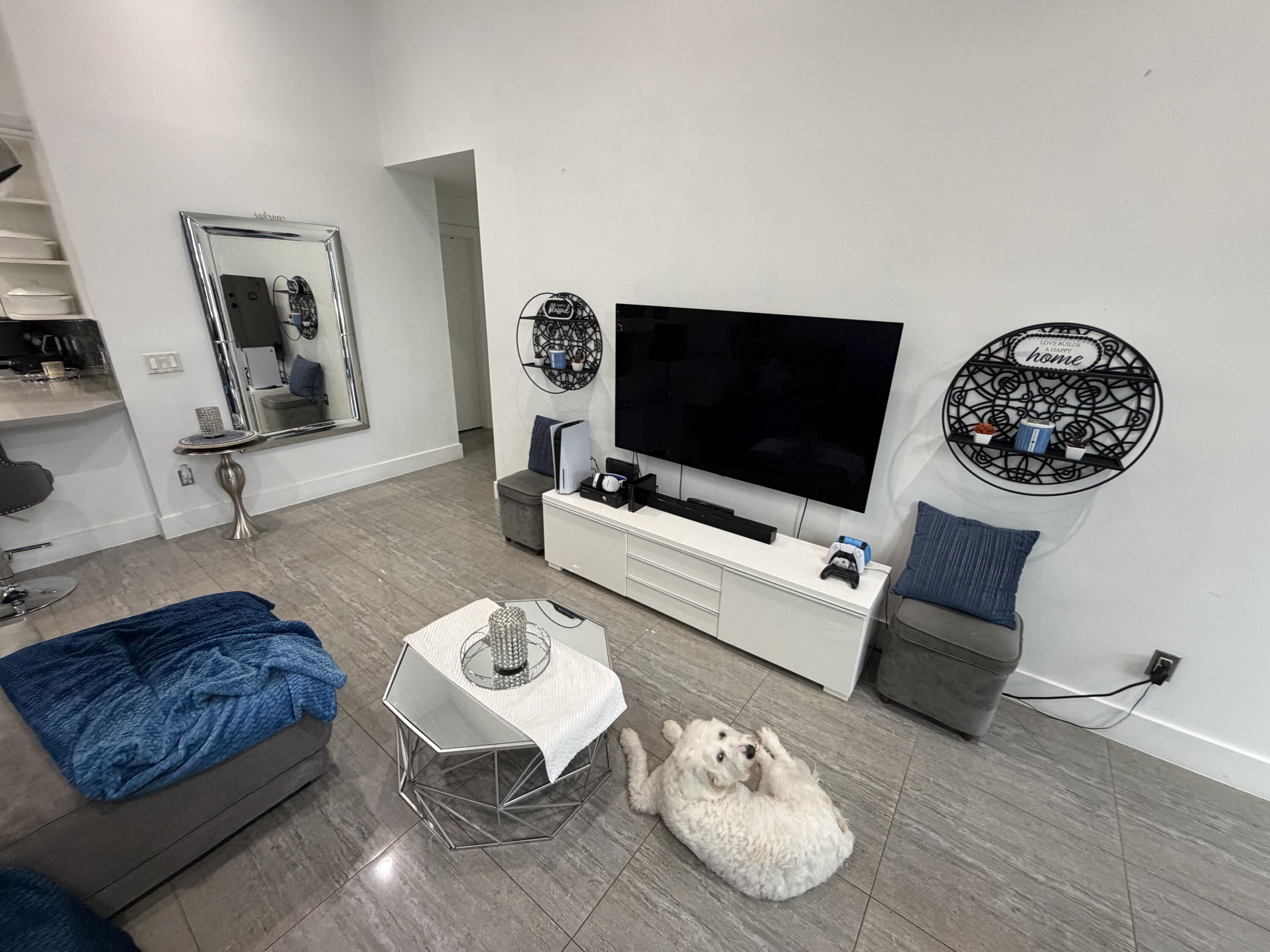 8097 Cedar Hollow Lane Boca Raton, FL 33433 - Photo 9 of 36 a living room with furniture and a flat screen tv