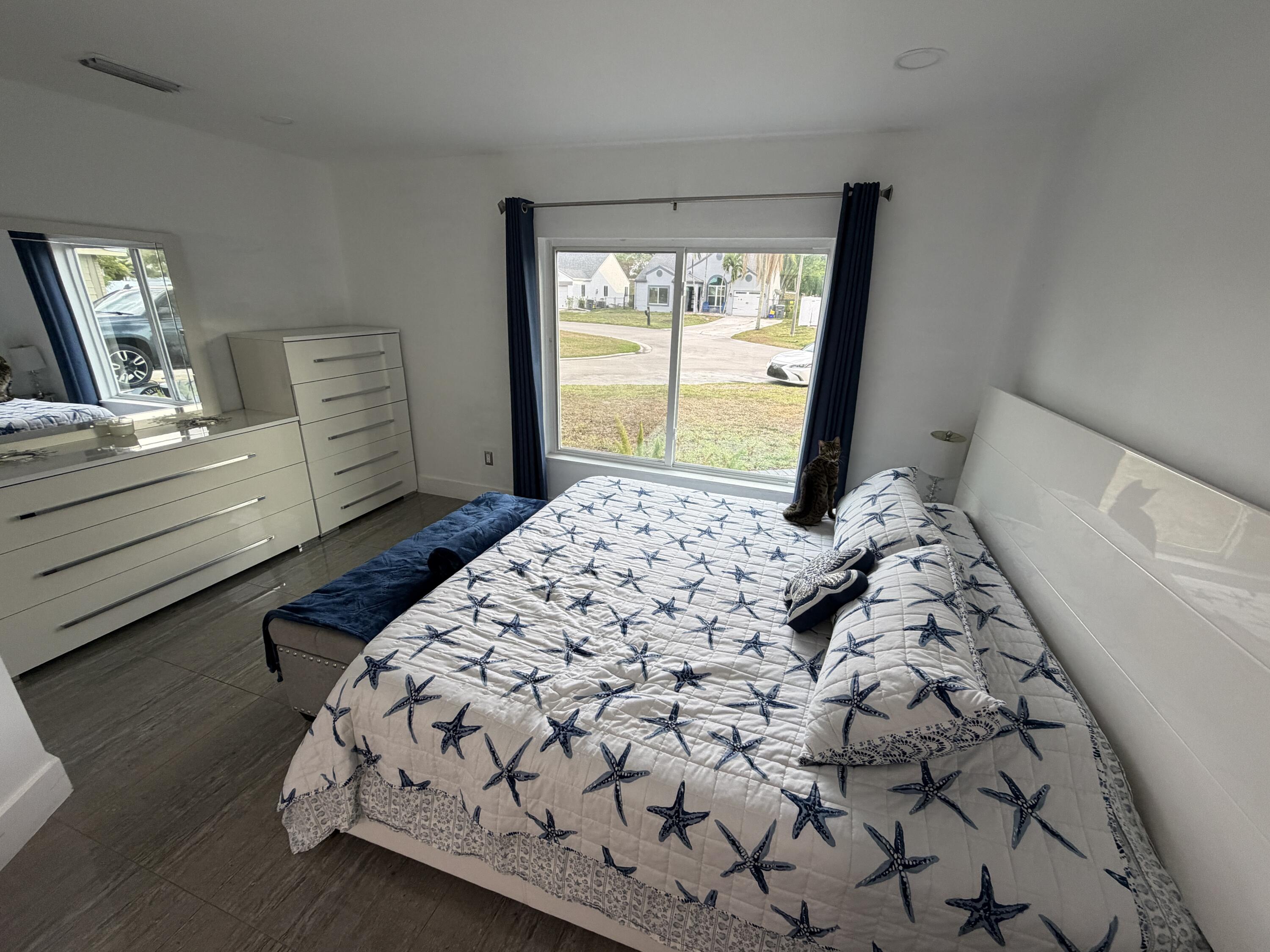 8097 Cedar Hollow Lane Boca Raton, FL 33433 - Photo 10 of 36 a bedroom with a large bed and a window