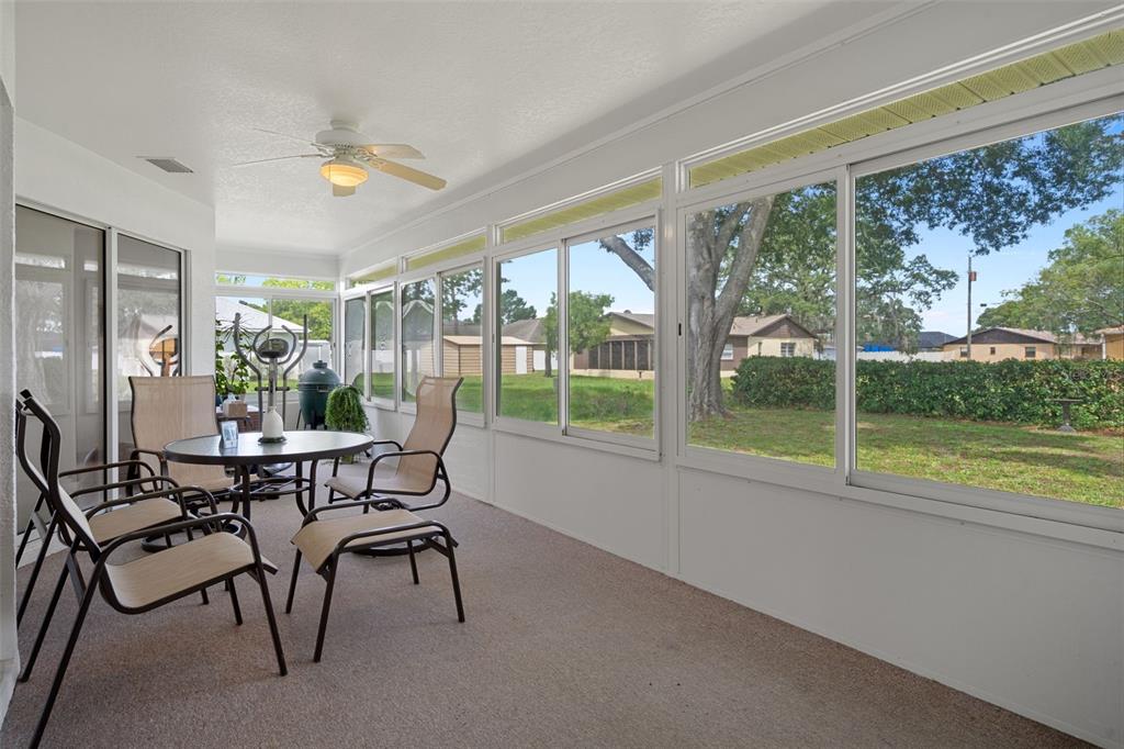 5035 Harbinger Road Spring Hill, FL 34608 - Photo 42 of 47 a dining room with furniture and floor to ceiling windows