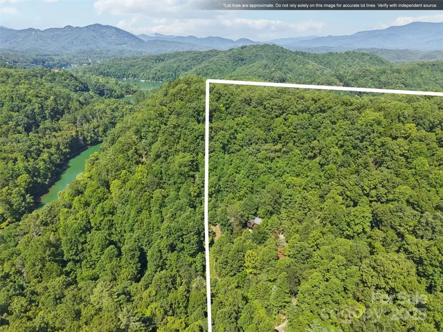 a view of a green field with mountains in the background