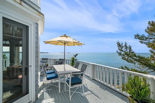 a view of balcony with wooden floor and outdoor seating