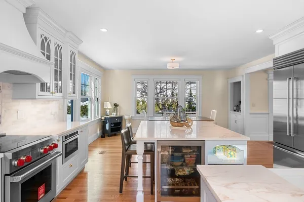 a large kitchen with stainless steel appliances granite countertop a stove and a refrigerator