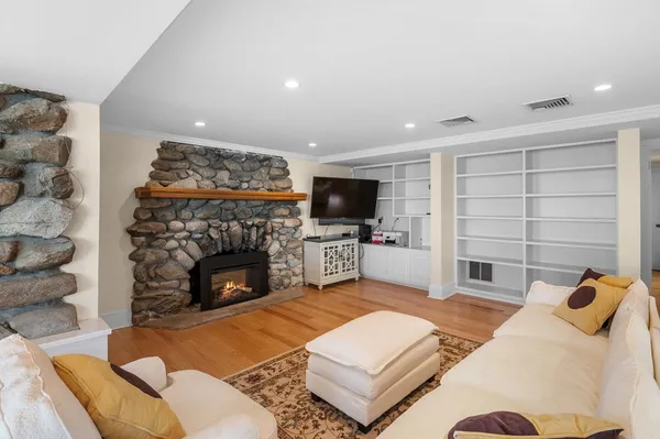a living room with furniture and a fireplace