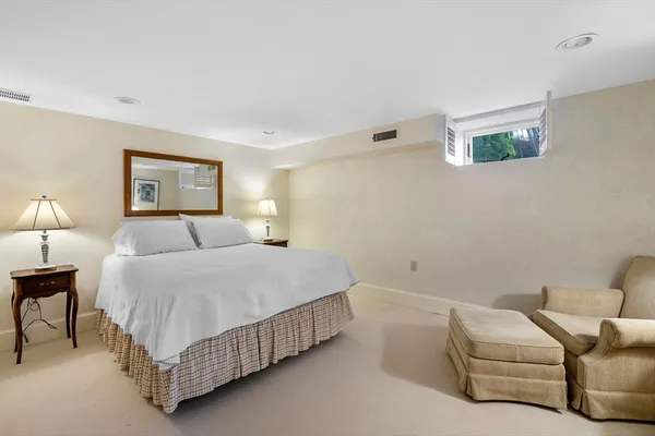 a bedroom with a bed couch and a lamp