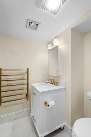 a bathroom with a sink toilet and mirror