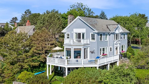 an aerial view of a house with a yard